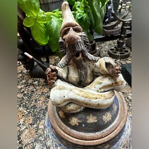 Pottery jar with lid with wizard on top.  Wizard holds incense in his hands!